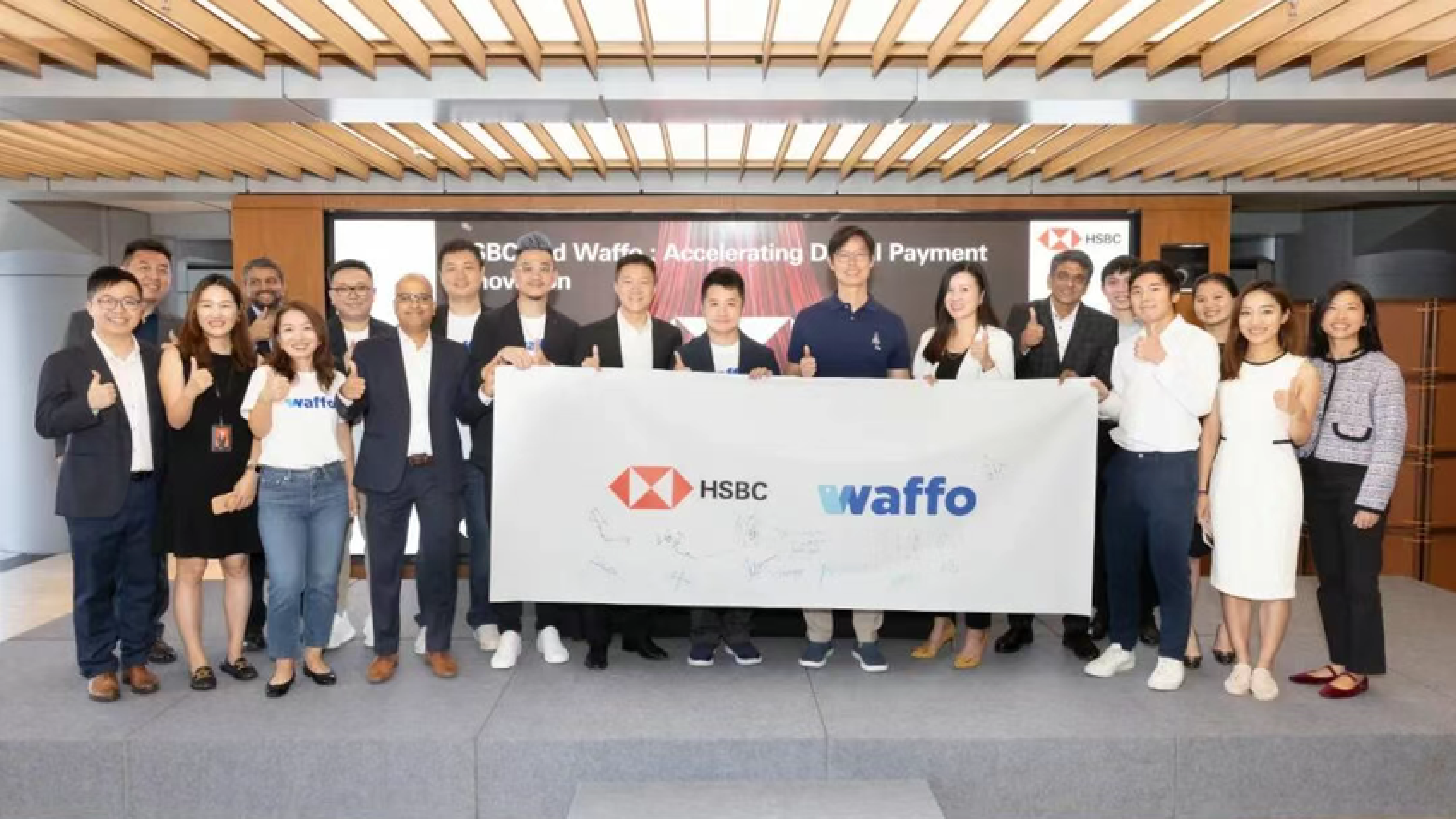Waffo and HSBC executives celebrate strategic equity investment.