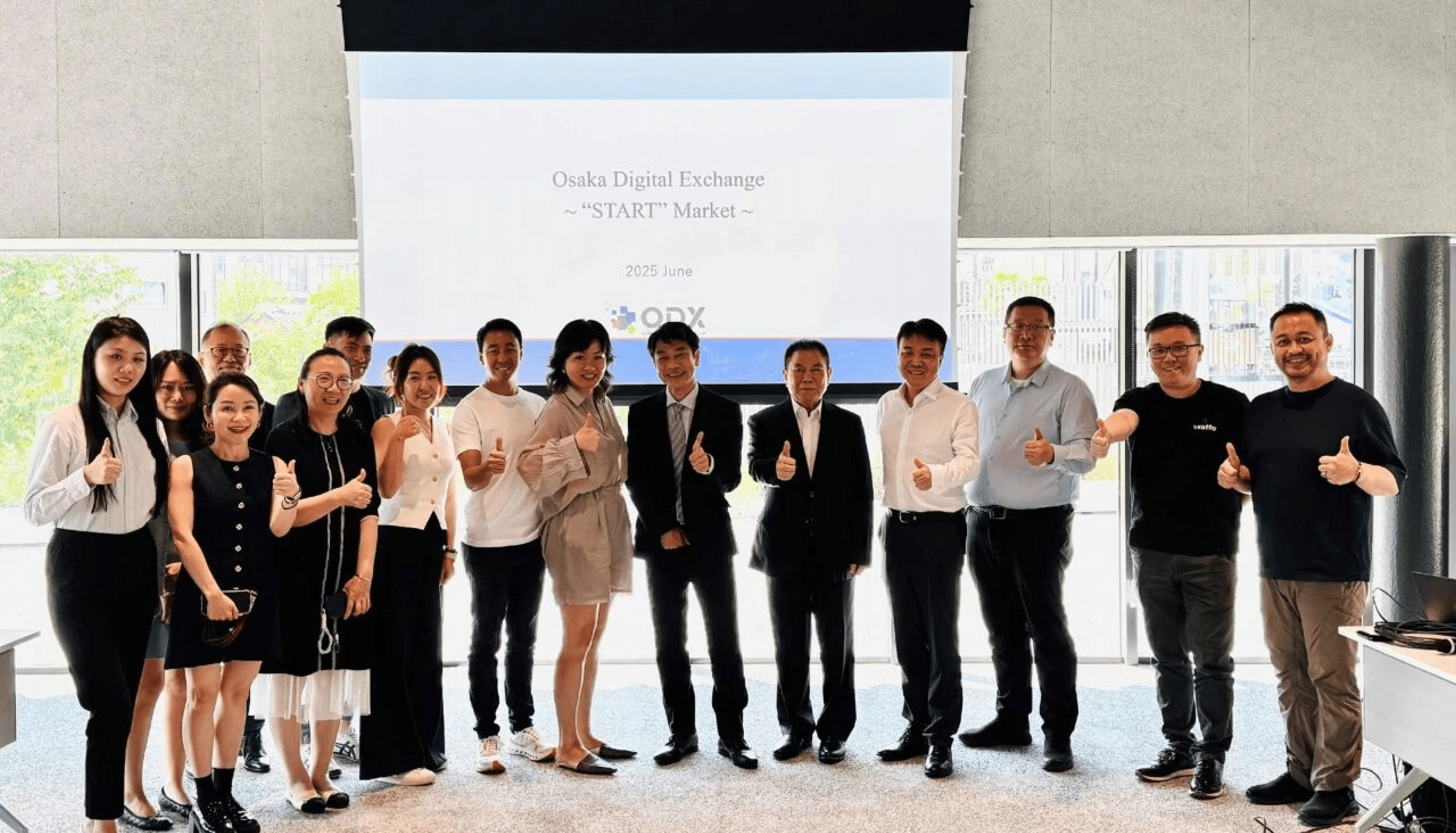 InvestHK delegation group photo with Osaka Digital Exchange executives in front of ODX START Market presentation screen.